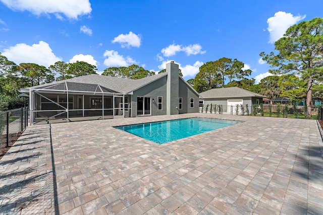 view of swimming pool with glass enclosure and a patio area