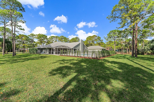 view of yard featuring glass enclosure