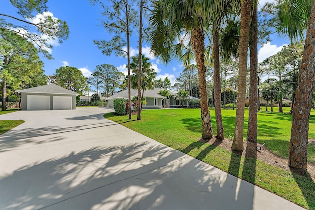 view of front of property with a garage and a front lawn