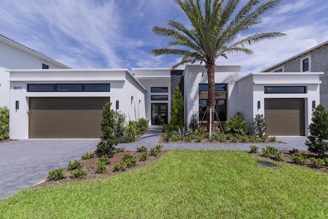 contemporary house with a garage and a front lawn