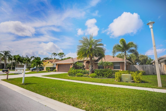 view of front of house with a garage and a front yard