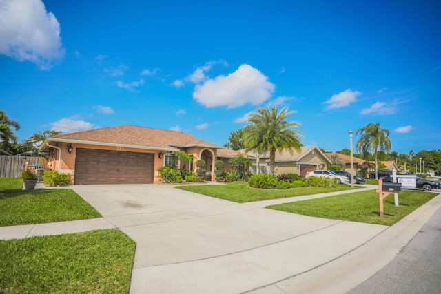 view of front of home featuring a garage and a front lawn