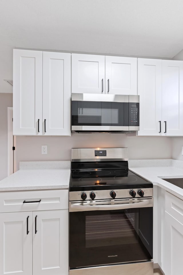 kitchen with white cabinetry and stainless steel appliances