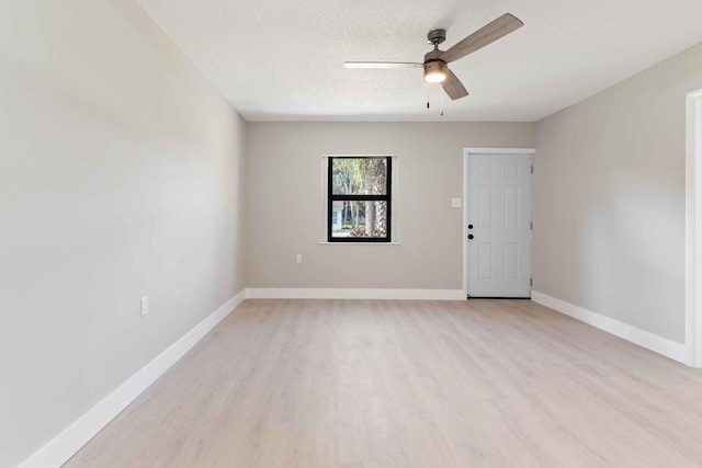 spare room featuring ceiling fan, a textured ceiling, and light wood-type flooring