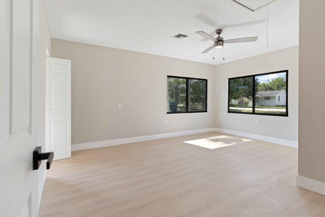 unfurnished room with ceiling fan and light hardwood / wood-style floors