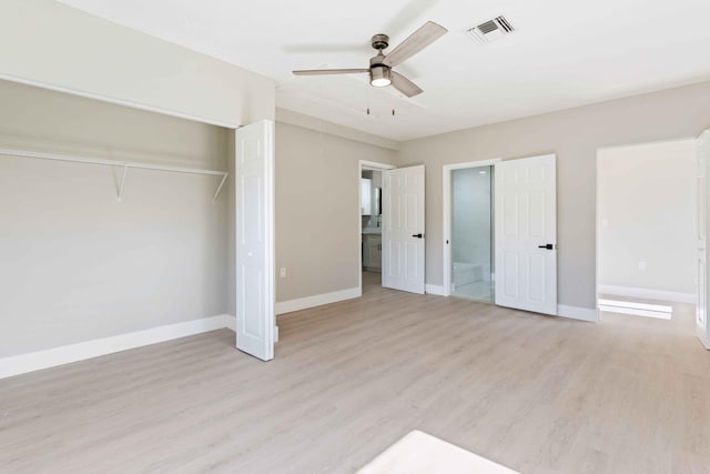 unfurnished bedroom with ceiling fan, ensuite bathroom, light wood-type flooring, and a closet