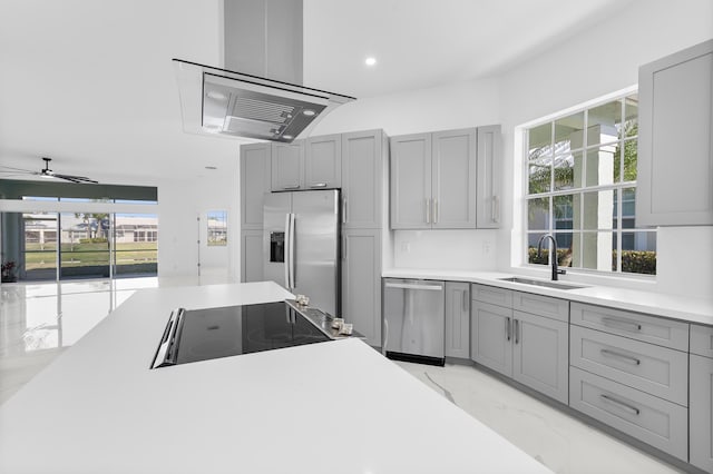 kitchen featuring sink, gray cabinetry, ceiling fan, stainless steel appliances, and range hood