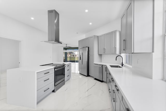 kitchen featuring sink, gray cabinets, ceiling fan, appliances with stainless steel finishes, and island range hood