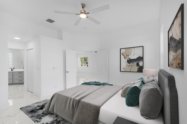 bedroom with ceiling fan and ensuite bath