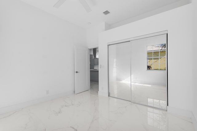 unfurnished bedroom featuring a closet and ceiling fan