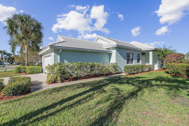 view of front of property featuring a garage and a front lawn