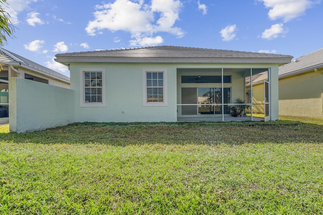 rear view of property featuring a yard