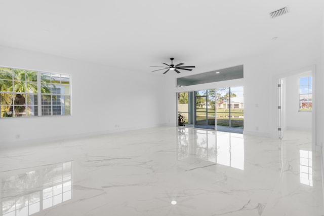 empty room with plenty of natural light and ceiling fan