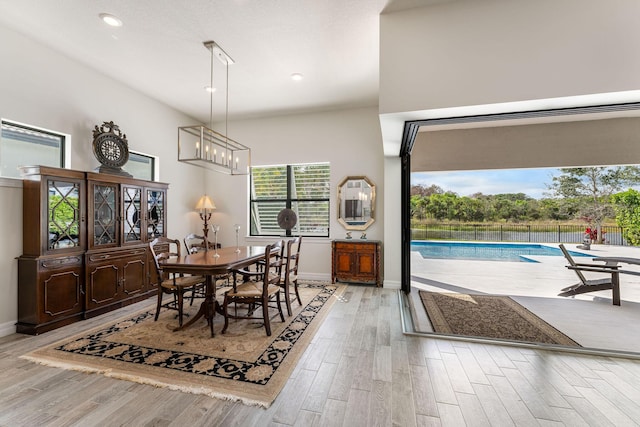 dining space with recessed lighting, baseboards, a chandelier, and light wood finished floors