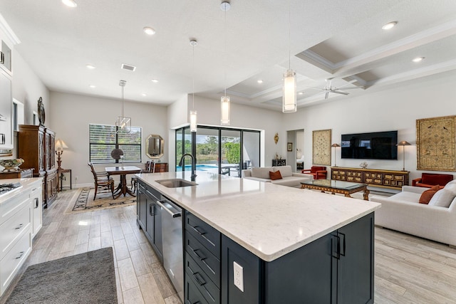 kitchen featuring light wood finished floors, open floor plan, coffered ceiling, white cabinetry, and a sink