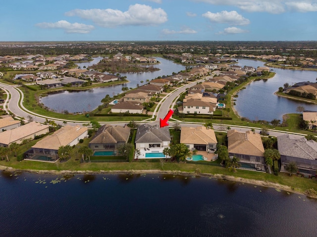 drone / aerial view featuring a residential view and a water view