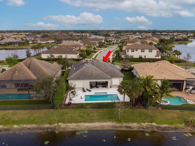 bird's eye view with a residential view and a water view