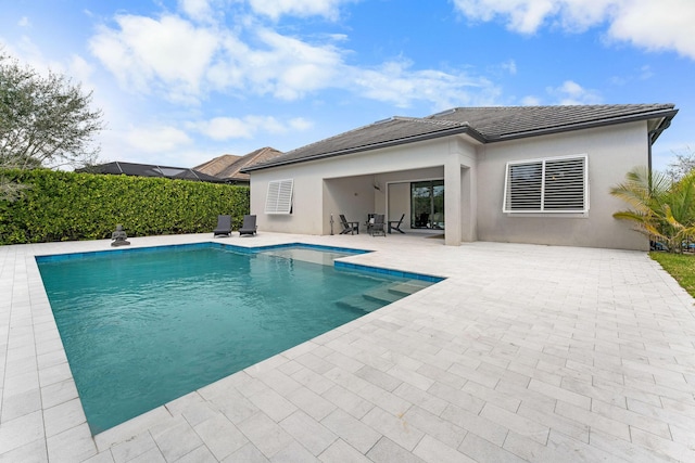 view of swimming pool with a fenced in pool and a patio