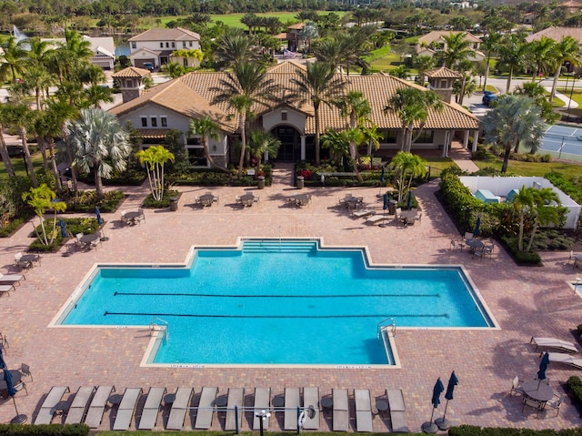 community pool featuring a patio area and fence