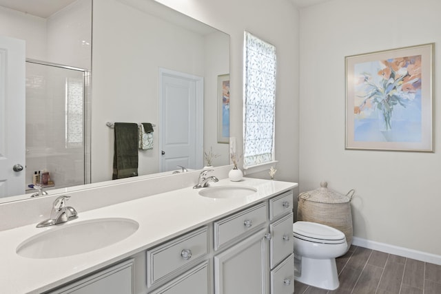 bathroom featuring vanity, toilet, and an enclosed shower