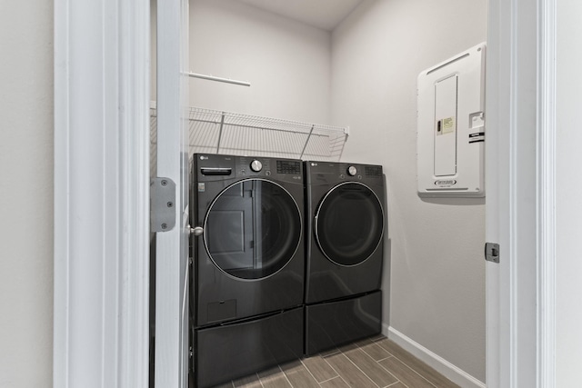 clothes washing area featuring independent washer and dryer and electric panel