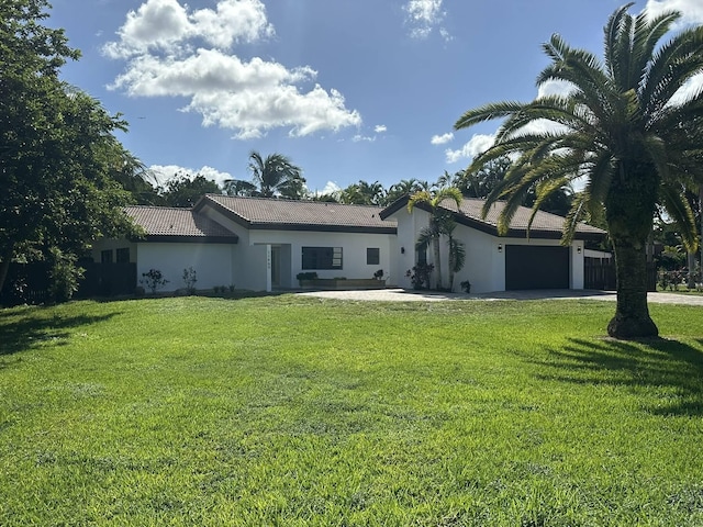 rear view of property with a yard and a garage