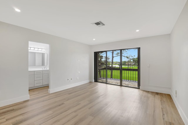 spare room featuring light wood-type flooring