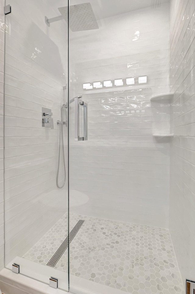 bathroom featuring a shower with door