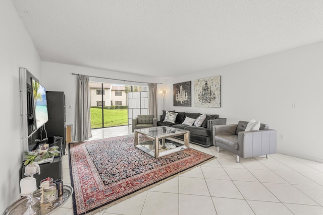 living room with a textured ceiling and light tile patterned flooring