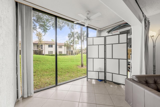 unfurnished sunroom with ceiling fan