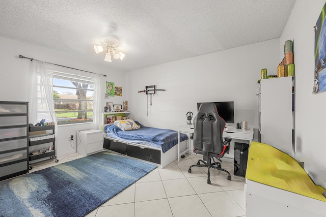 tiled bedroom featuring a textured ceiling