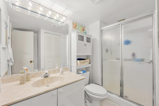 bathroom with vanity, toilet, and walk in shower