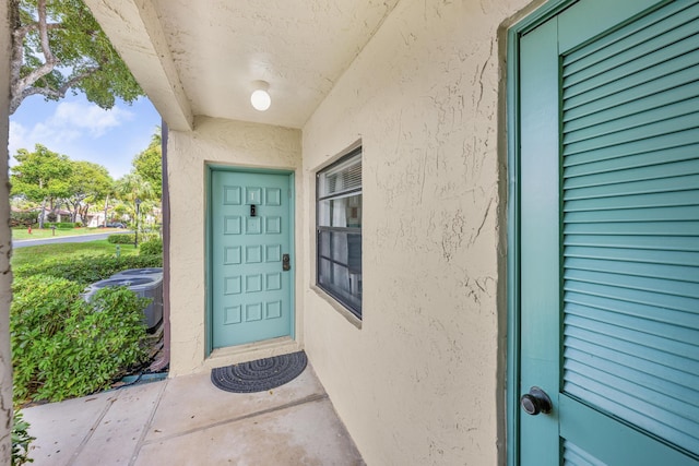 property entrance with central AC unit