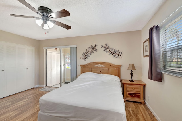 bedroom featuring ceiling fan, light wood finished floors, and baseboards