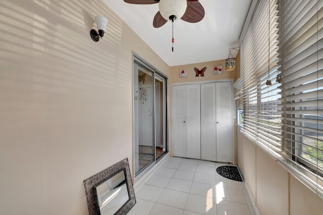 unfurnished bedroom featuring a closet, light tile patterned flooring, and ceiling fan