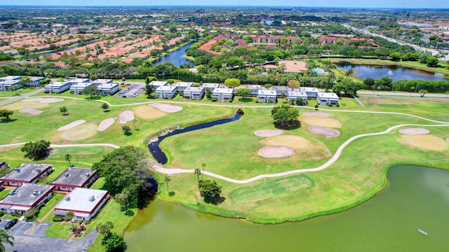 drone / aerial view with view of golf course, a water view, and a residential view