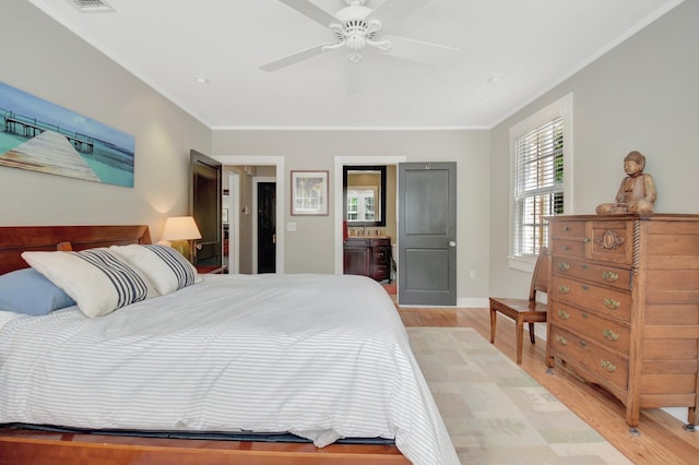 bedroom featuring ornamental molding, light wood-style flooring, baseboards, and a ceiling fan