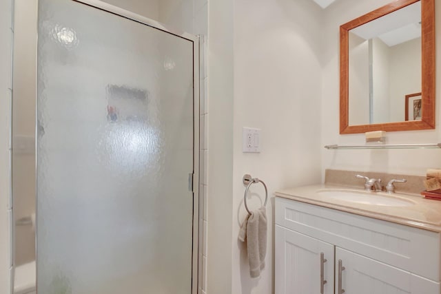 bathroom featuring a shower stall and vanity