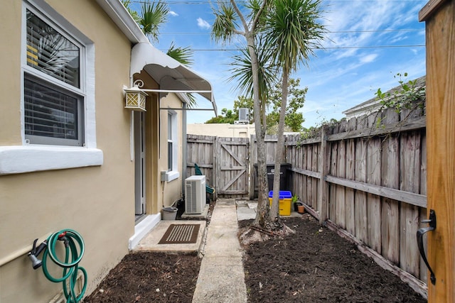 view of yard with ac unit, a gate, and fence