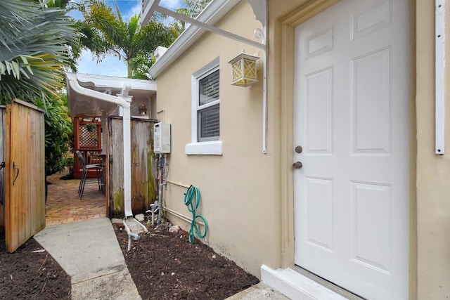 entrance to property featuring stucco siding