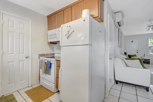 kitchen featuring a wall unit AC, light tile patterned flooring, white appliances, a ceiling fan, and light countertops