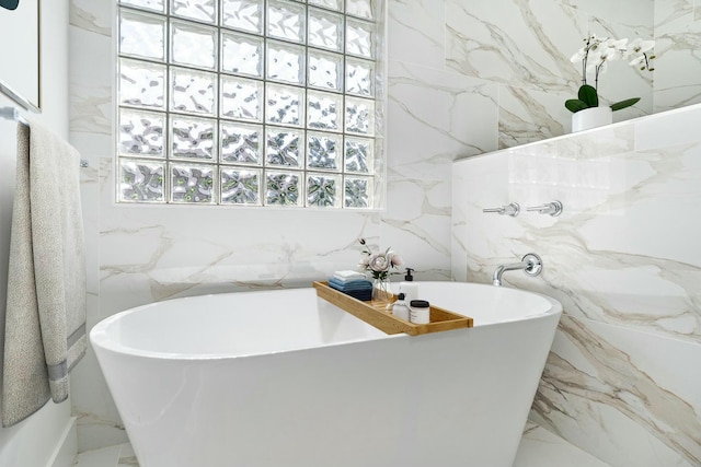 bathroom with plenty of natural light and a tub to relax in