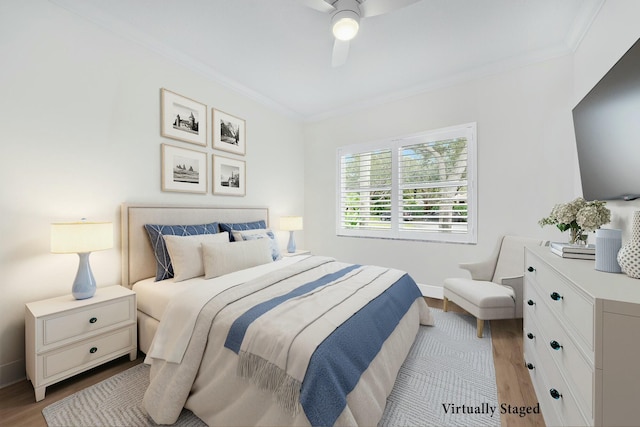 bedroom featuring crown molding, ceiling fan, and light hardwood / wood-style floors