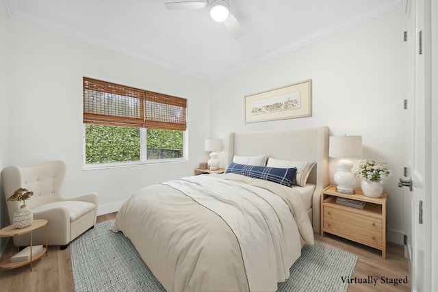 bedroom featuring ornamental molding, ceiling fan, and light wood-type flooring