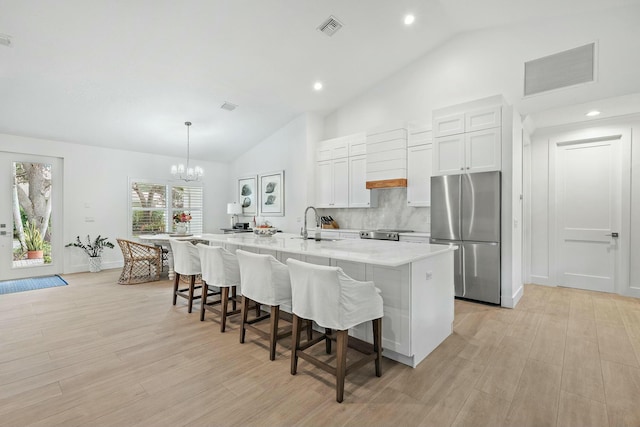 kitchen featuring hanging light fixtures, white cabinetry, appliances with stainless steel finishes, and a large island