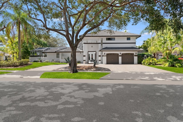 mediterranean / spanish home featuring a garage and a lanai