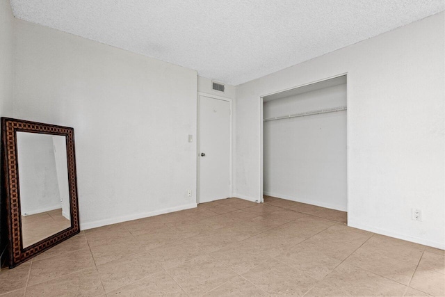 unfurnished bedroom featuring a closet and a textured ceiling