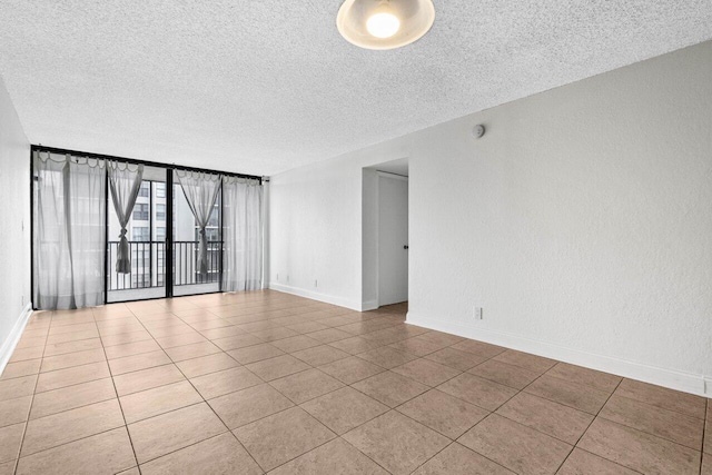 tiled spare room with a textured ceiling