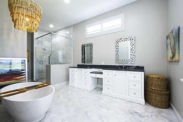 bathroom with baseboards, marble finish floor, a soaking tub, a shower stall, and double vanity