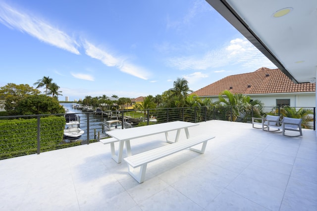 view of patio / terrace featuring a water view and a balcony